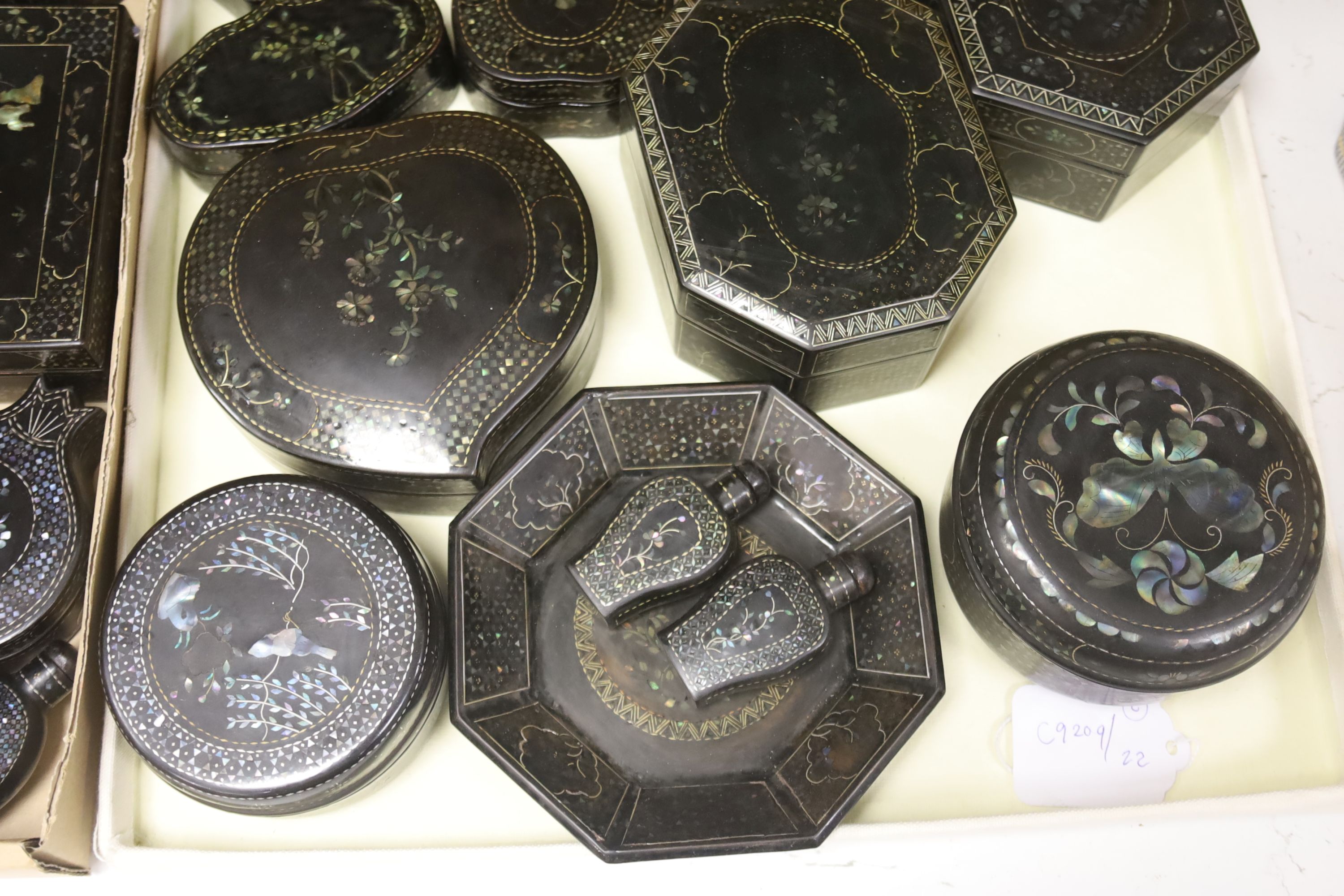 A quantity of Lac Burgaute boxes, inlaid with mother of pearl, largest 13cm diameter 10cm high (26)